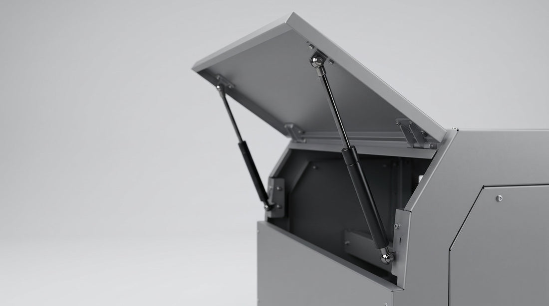 Metal lid held open by two gas springs mounted on the side